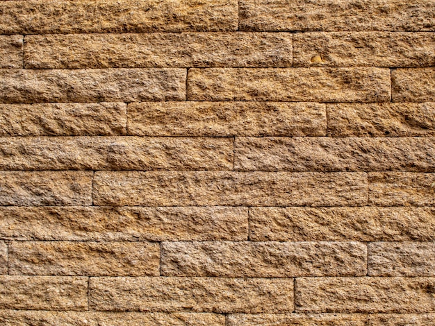 Foto close-up di una parete di mattoni di arenaria per lo sfondo