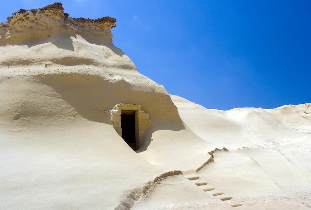 Sandstone cave entrance at Qbaijar on the island of Gozo Malta