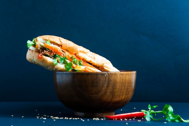 sandwich in bowl on black background
