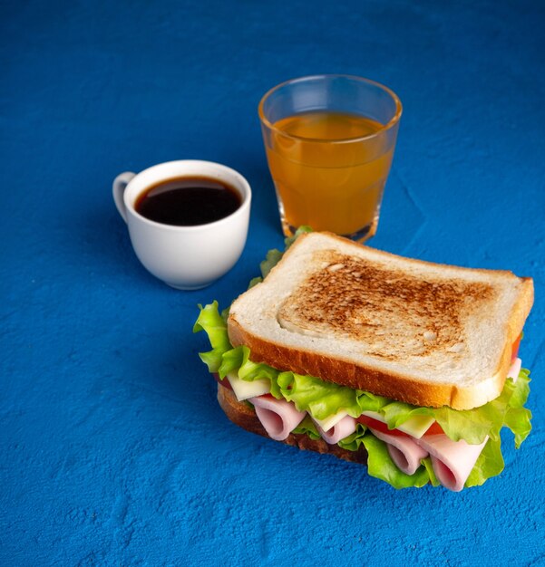 Sandwich, coffee and juice. Breakfast.