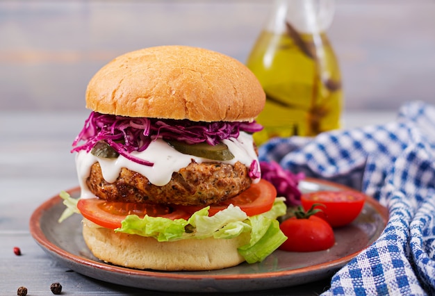 Sandwich hamburger with juicy burgers, tomato and red cabbage