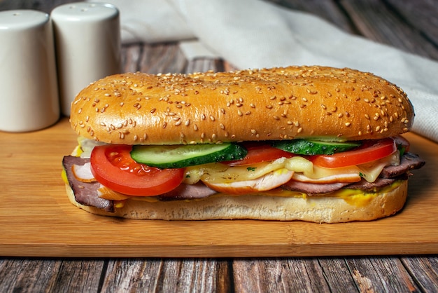 Sandwich met sesambroodje, kaas, ham en verse groenten