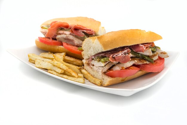 Photo sandwich serranito typical in andalusia with ham, gren pepper and grilled pork loin
