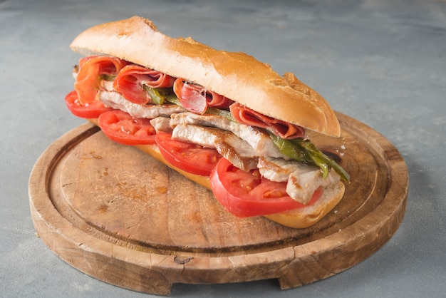 Sandwich Serranito typical in Andalusia with ham