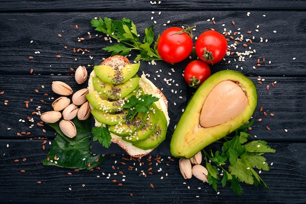 Sandwich with avocado butter and chia seeds On a wooden background Top view Free space for your text