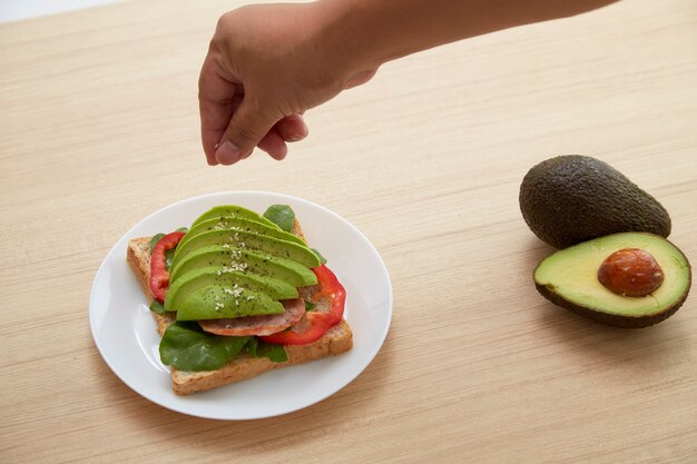 Sandwich with avocado slices and bacon