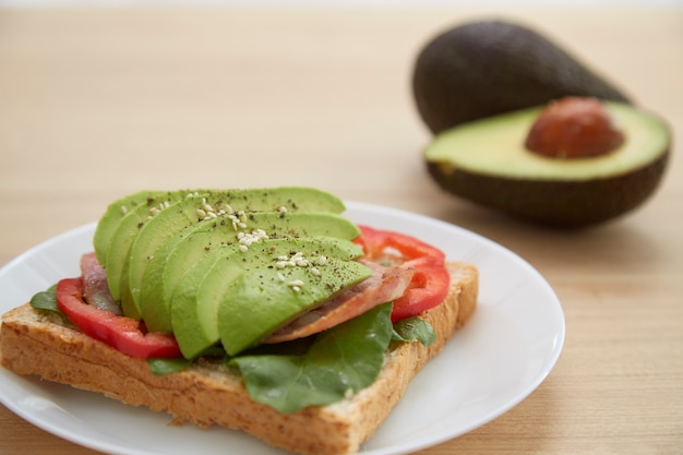 Sandwich with avocado slices and bacon