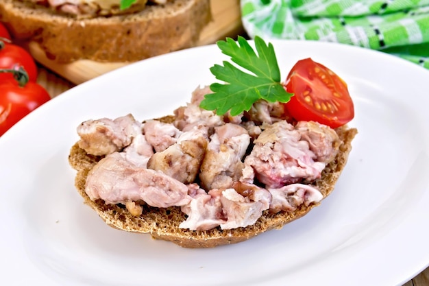 Sandwich with brains and parsley in plate on board