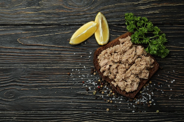 Sandwich with canned tuna on wooden background