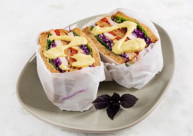 Sandwich with chicken fillet red cabbage and sauce wrapped in paper Take along