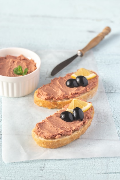 Sandwich with chicken liver pate and black olives