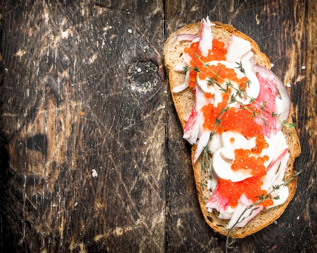 Premium Photo | Sandwich with crab meat, mushrooms and red caviar