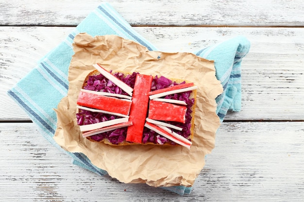 Photo sandwich with flag of great britain on table closeup