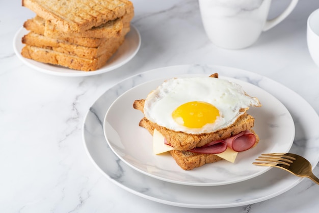 Sandwich with a fried egg bacon cheese and spinach