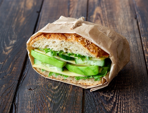 Sandwich with green salad, avocado cucumber and cheese