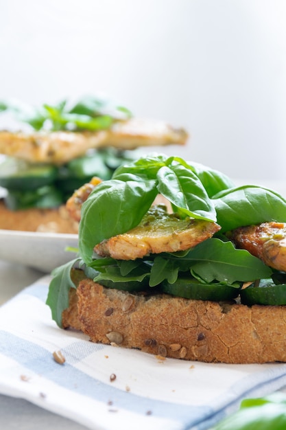 Sandwich with grilled chicken meat and basil pesto