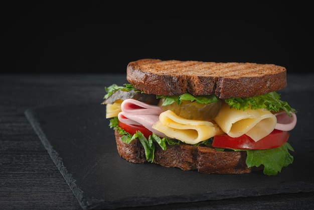 Sandwich with ham cheese tomatoes lettuce and toasted bread