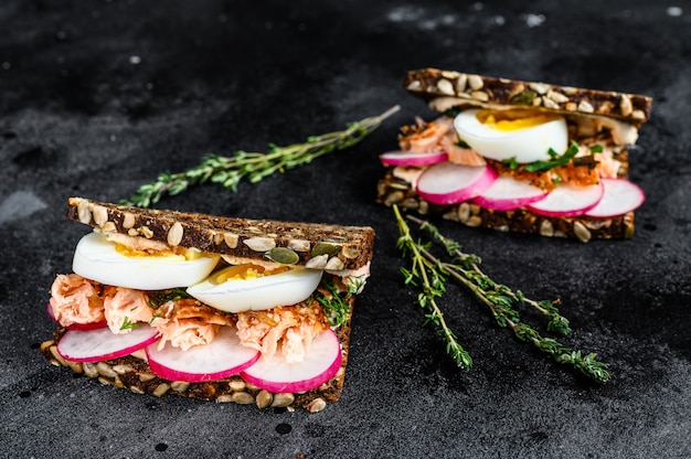 Sandwich with hot smoked salmon and grain bread. trout.