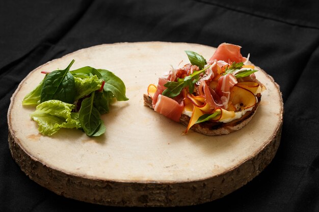 Sandwich with jamon and lettuce on a wooden tray