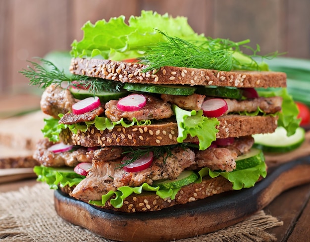 Sandwich with meat vegetables and slices of rye bread