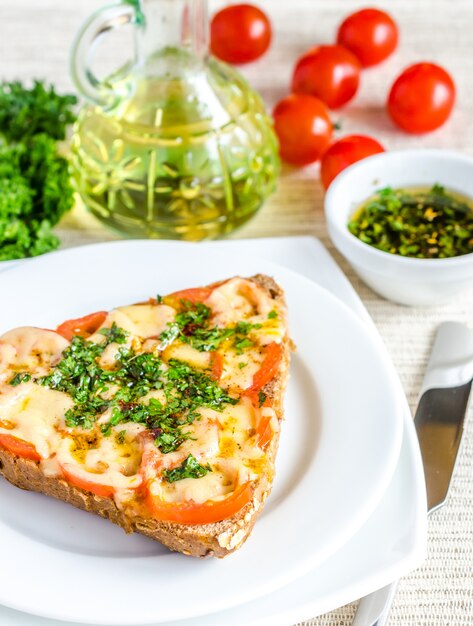 Sandwich with melted cheese and tomatoes