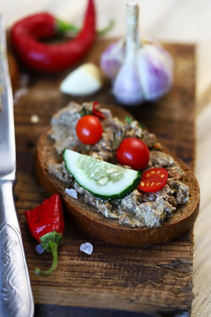 Sandwich with pate on a wooden board