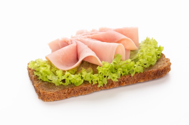 Sandwich with pork ham on white.