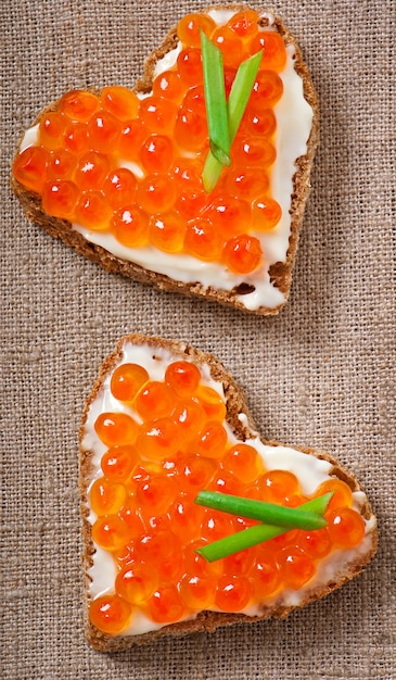 Photo sandwich with red caviar in the form of a heart