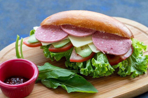 Sandwich with salami cheddar tomato cucumber lettuce arugula in bread quick snack delicious sandwich