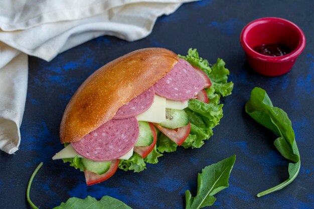 Sandwich with salami cheddar tomato cucumber lettuce arugula in bread quick snack delicious sandwich