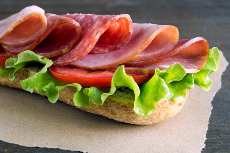 Sandwich with salami, ham and salad.