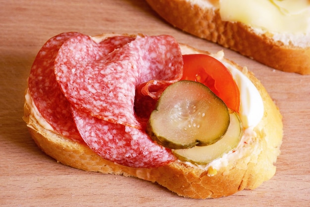 sandwich with salami and pickled cucumber