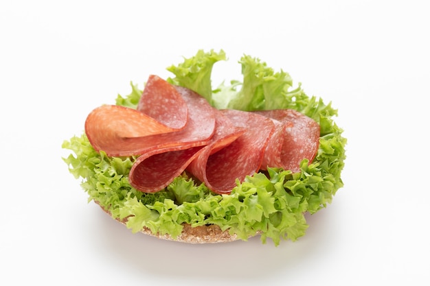 Sandwich with salami sausage on white background.