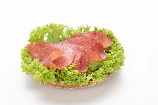 Sandwich with salami sausage on white background.