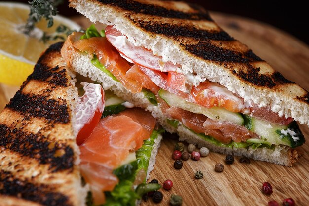 Sandwich with salmon tomatoes cucumber and spices