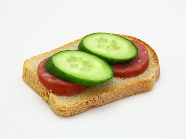 Sandwich with sausage and a cucumber