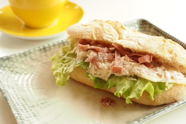 Sandwich with smoked chicken salami on table