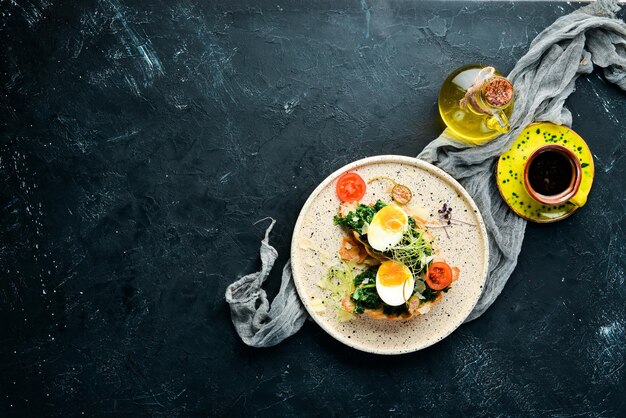 Sandwich with spinach egg and tomatoes croissant Breakfast In the plate Top view Flat lay composition Free copy space