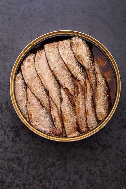 Sandwich with sprats on a black background