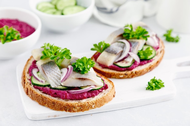 Sandwiches toasts with salted herring and beetroot pate