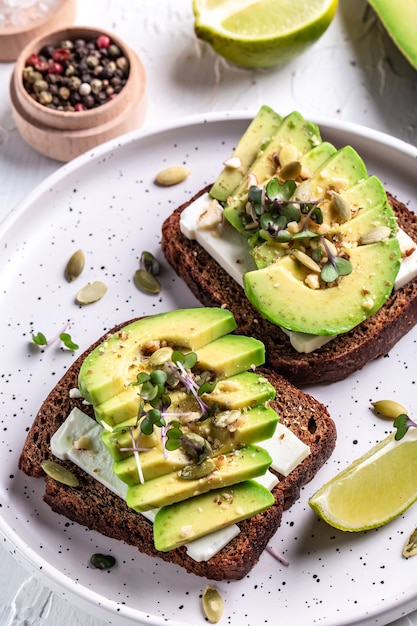 Sandwiches with avocado, cheese, pumpkin, nut and sesame