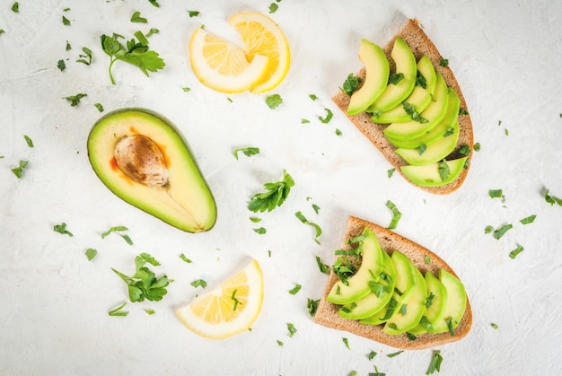 Sandwiches with avocado, lemon and greens