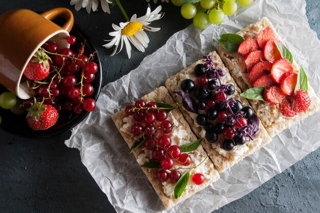 Sandwiches with berries and cottage cheese on diet bread. Healthy food concept