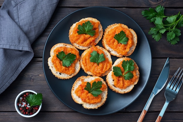 Sandwiches with bread zucchini caviar tomatoes onions. Homemade vegetarian food. Canned stewed vegetable. wooden background