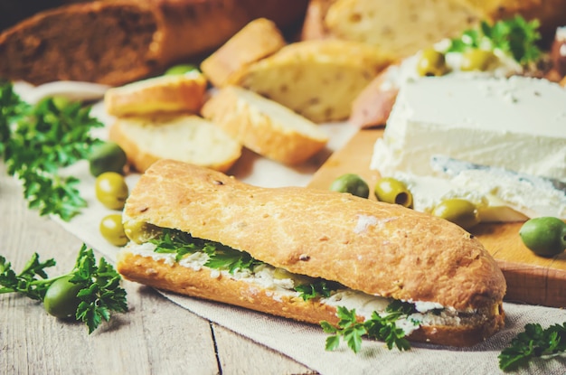 Sandwiches with cheese and olives. Selective focus.