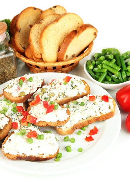 Sandwiches with cottage cheese and greens on plate isolated on white