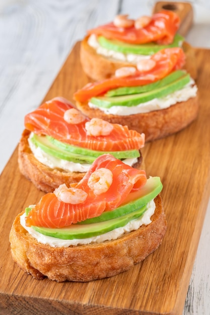 Sandwiches with cream cheese avocado and salmon