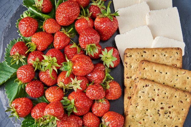 Sandwiches with fresh berries on a dark, top view