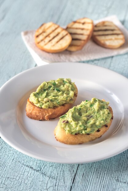 Sandwiches with guacamole on plate