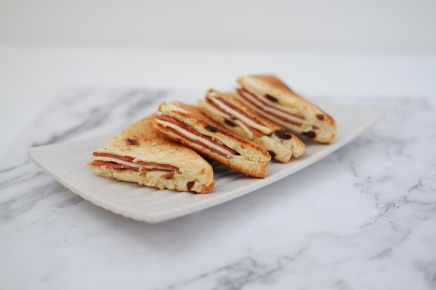 Sandwiches with ham cheese and raisinsle background